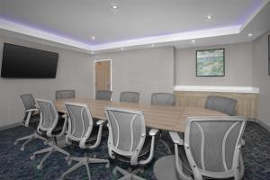 a conference room with a wooden table and chairs at Home2 Suites by Hilton Chelmsford Lowell in Chelmsford