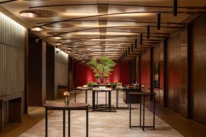 a hallway with a row of tables in a building at Grand Hyatt Kunming in Kunming