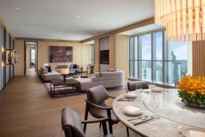 a living room with a table and chairs at Grand Hyatt Kunming in Kunming