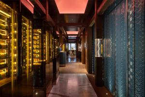 a hallway of a wine tasting room with wine bottles at Grand Hyatt Kunming in Kunming