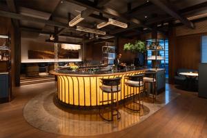 a kitchen with a bar with stools around it at Grand Hyatt Kunming in Kunming +107 photos