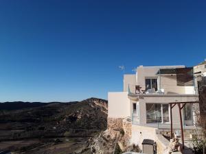 a house on the side of a mountain at Casas Rurales Planeta Chicote in Zafra de Záncara