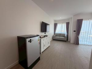 a living room with a refrigerator and a couch at The View Hotel โรงแรมเดอะวิว นครศรีธรรมราช in Nakhon Si Thammarat