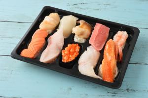 a black tray filled with different types of sushi at Private Sauna The room 20 in Hakodate +14 photos