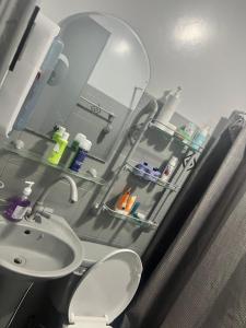 a bathroom with a sink and a mirror at Heart of Pasig in Manila