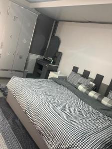 a bedroom with a bed and a desk in it at Heart of Pasig in Manila
