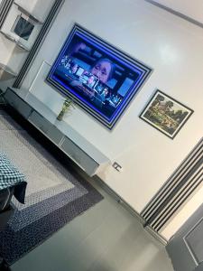 a flat screen tv on a wall in a living room at Heart of Pasig in Manila