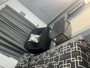 a bedroom with a chair next to a bed at Heart of Pasig in Manila +15 photos