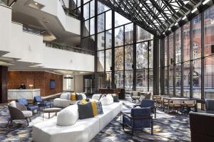 a lobby with couches and chairs and large windows at DoubleTree by Hilton Hotel Philadelphia Center City in Philadelphia