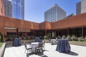 a patio with tables and chairs in front of a building at DoubleTree by Hilton Hotel Philadelphia Center City in Philadelphia