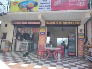 a shop with a table and chairs in a store at Sai Homestay in Mussoorie