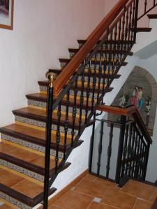a staircase with wood treads with a picture of two people at Hotel Rural Casares in Casares