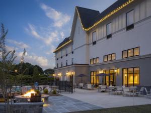 a hotel with a fire pit in front of a building at Hampton Inn & Suites Braselton in Braselton