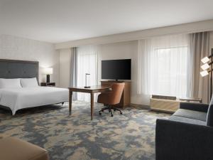 a hotel room with a bed and a desk at Hampton Inn & Suites Braselton in Braselton