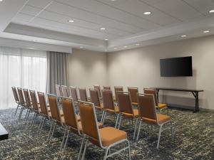 a conference room with chairs and a flat screen tv at Hampton Inn & Suites Braselton in Braselton +21 photos