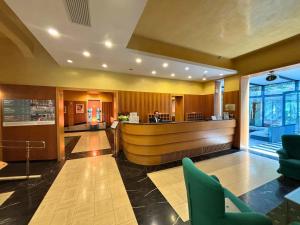 a hotel lobby with a reception desk and chairs at Hotel Terme in Monticelli Terme +39 photos