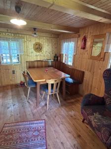 a dining room with a wooden table and chairs at HeinrichH in Teuchl