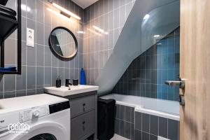 a bathroom with a sink and a washing machine at BORG VendégHázak - Tiszakécske in Tiszakécske +11 photos