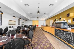 a restaurant with tables and chairs and a counter at Quality Hotel Point Cook in Point Cook