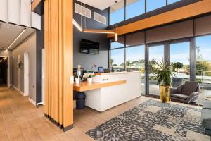 an office lobby with a counter and a living room at Quality Hotel Rules Club Wagga in Wagga Wagga
