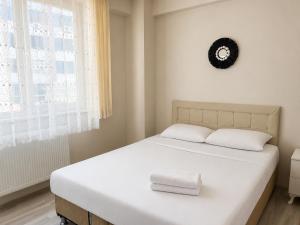 a bedroom with a bed with two towels on it at Bolu novara suit in Bolu