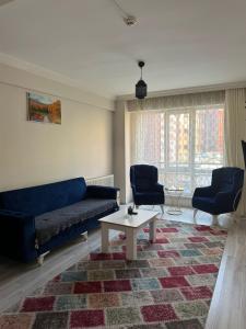 a living room with a blue couch and a coffee table at Bolu novara suit in Bolu