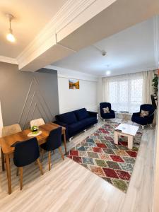 a living room with a blue couch and a table at Bolu novara suit in Bolu +2 photos