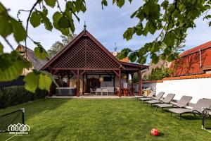 a pavilion with chairs on a lawn at BORG VendégHázak - Tiszakécske in Tiszakécske