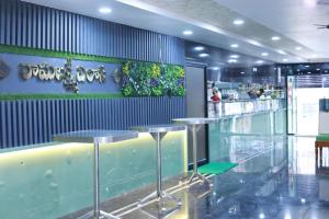 a restaurant with two tables and a bar in it at SRL Grand Residency in Tirupati +10 photos