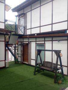 a porch of a house with a swing at Bird Nest Hostel in Ko Tao