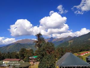 a view of the mountains with a tent and clouds at grand holiday camp in Sari +2 photos