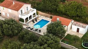 an aerial view of a house with a swimming pool at Leggiero in Benkovac