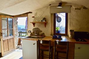 a kitchen with a sink and a counter with a window at Place of Peace and Reflection Valchiusella in Brosso