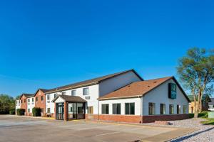 a large white building with a parking lot at Quality Inn Fairfield in Fairfield