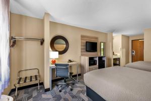 a hotel room with a bed and a desk at Quality Inn Fairfield in Fairfield +37 photos