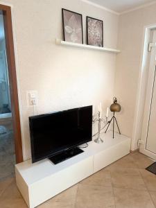 a living room with a flat screen tv on a white entertainment center at Monteurwohnung,Ferienwohnung in Lüdenscheid