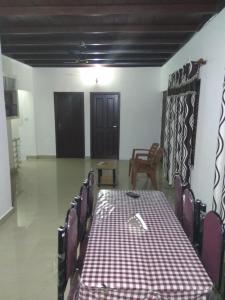 a dining room with a table and chairs in a room at Elroy Homestay in Kalpetta