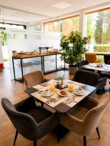 a dining room with a table and chairs at Info Hotel in Palanga