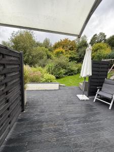 a patio with an umbrella and a chair at Monteurwohnung,Ferienwohnung in Lüdenscheid