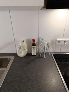 a kitchen counter with a bottle of wine and a fan at Monteurwohnung,Ferienwohnung in Lüdenscheid +2 photos