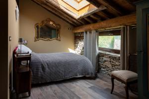 a bedroom with a bed and a skylight at Little Chariot in Monastero di Lanzo