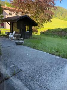 a building with a bench next to a field at Pâquier 3 in Saint-Sulpice