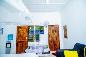 a living room with wooden doors and a table at Avana Studio Watamu in Watamu