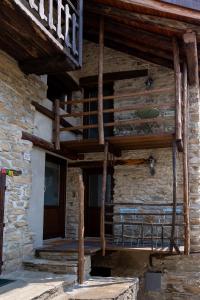 a building with a wooden porch and a balcony at Little Chariot in Monastero di Lanzo