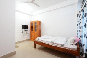 a small bedroom with a bed in a room at Hotel Zimin Ziro in Ziro +24 photos