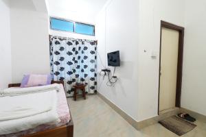 a small room with a bed and a window at Hotel Zimin Ziro in Ziro