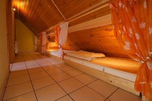 a room with a bed in a wooden cabin at Bringatanya in Balatonkenese