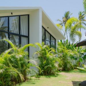 a white house with plants in front of it at Air Villa in Ahangama