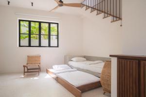 a living room with two beds and a staircase at Air Villa in Ahangama