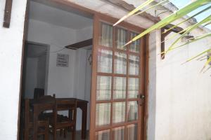 an open door to a room with a table and a chair at Apartamentos Flor de Lis in La Paloma